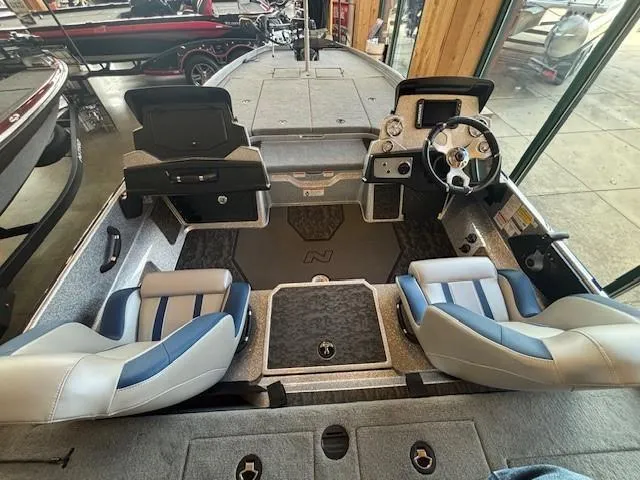 Slide: The Image of 2025 Nitro Z21 XL boat interior with dual seats and steering console. - 2