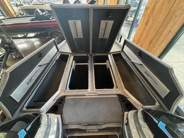 Slide: The Image of 2025 Nitro Z21 XL boat storage compartments open, showcasing spacious interior design. - 3