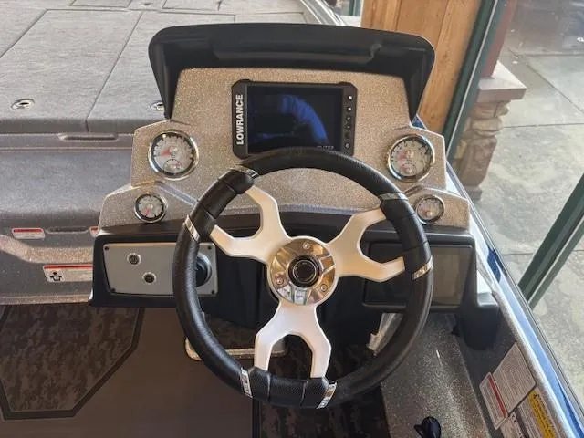 Slide: The Image of 2025 Nitro Z21 XL boat dashboard with steering wheel and Lowrance display. - 5