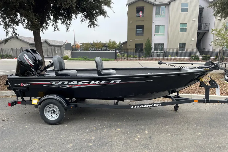 The Image of 2025 Tracker Super Guide V-16 T boat on trailer, parked outdoors. - 0
