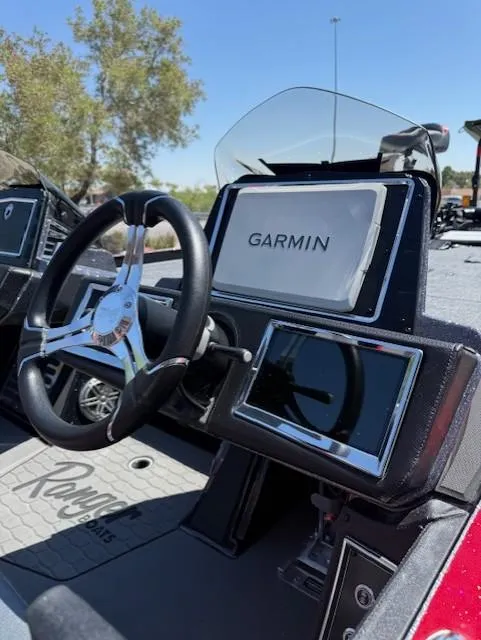 Slide: The Image of 2025 Ranger Z521R boat dashboard with Garmin navigation system and steering wheel. - 4