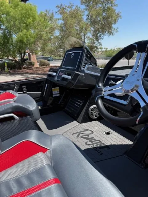 Slide: The Image of 2025 Ranger Z521R boat interior with sleek dashboard and steering wheel, featuring red and gray seating. - 5