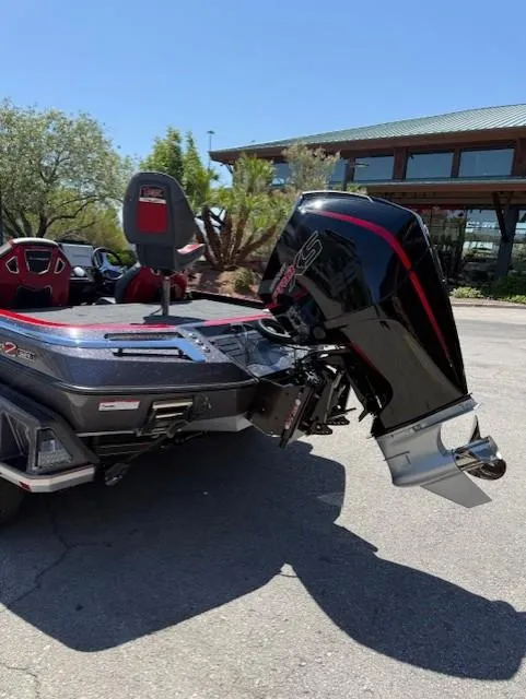 Slide: The Image of 2025 Ranger Z521R boat with powerful outboard motor, parked outdoors on a sunny day. - 9