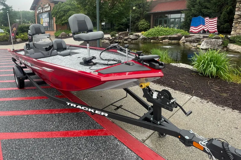 Slide: The Image of 2025 Tracker Pro 170 boat with Mercury 40 HP engine, parked outdoors. - 2