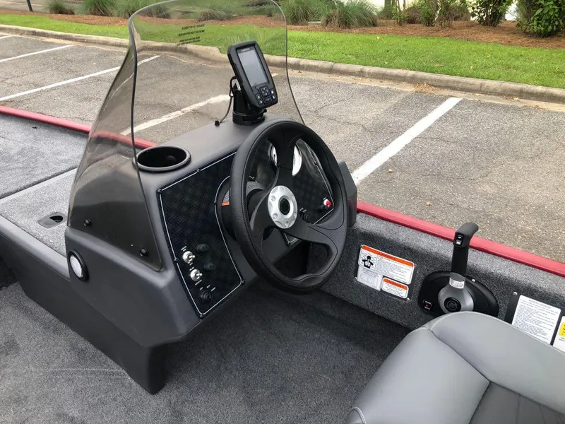 Slide: The Image of 2025 Tracker Bass Tracker Classic XL boat dashboard with steering wheel and control panel. - 10