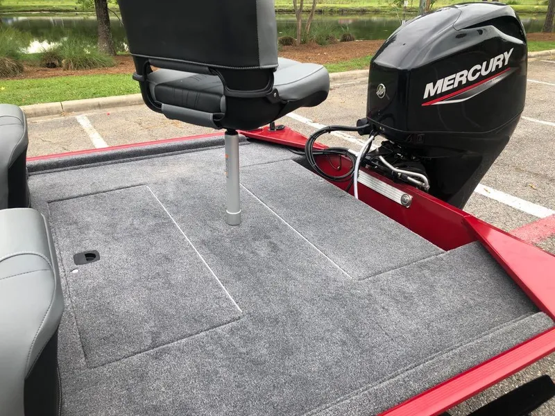 Slide: The Image of 2025 Tracker Bass Tracker Classic XL boat with Mercury motor, gray carpeted deck. - 11