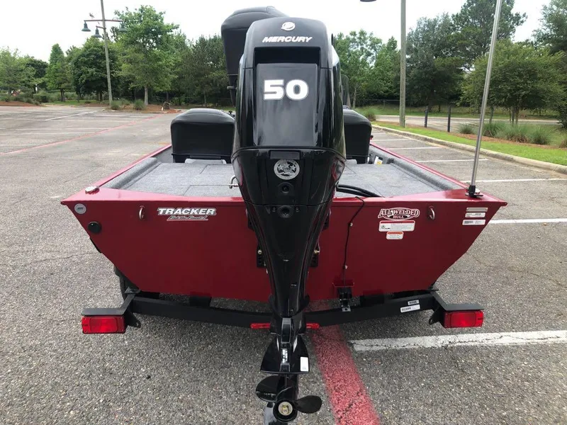 Slide: The Image of 2025 Tracker Bass Tracker Classic XL boat with Mercury 50 engine in parking lot. - 2