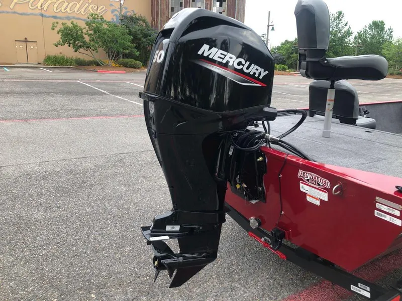 Slide: The Image of 2025 Tracker Bass Tracker Classic XL with Mercury outboard motor in parking lot. - 3