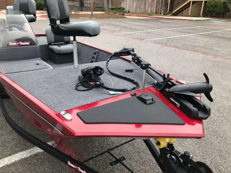 Slide: The Image of 2025 Tracker Bass Tracker Classic XL boat with Minn Kota trolling motor in parking lot. - 7