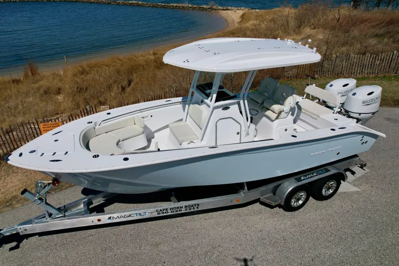 Slide: The Image of 2025 Cape Horn 24 XS boat on trailer by the shoreline. - 16