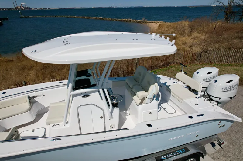 Slide: The Image of 2025 Cape Horn 24 XS boat with dual Suzuki engines, docked near a scenic coastline. - 17