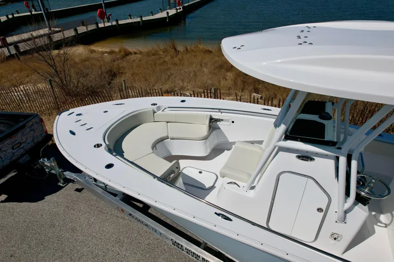 Slide: The Image of 2025 Cape Horn 24 XS boat with spacious seating, docked near a serene waterfront. - 18