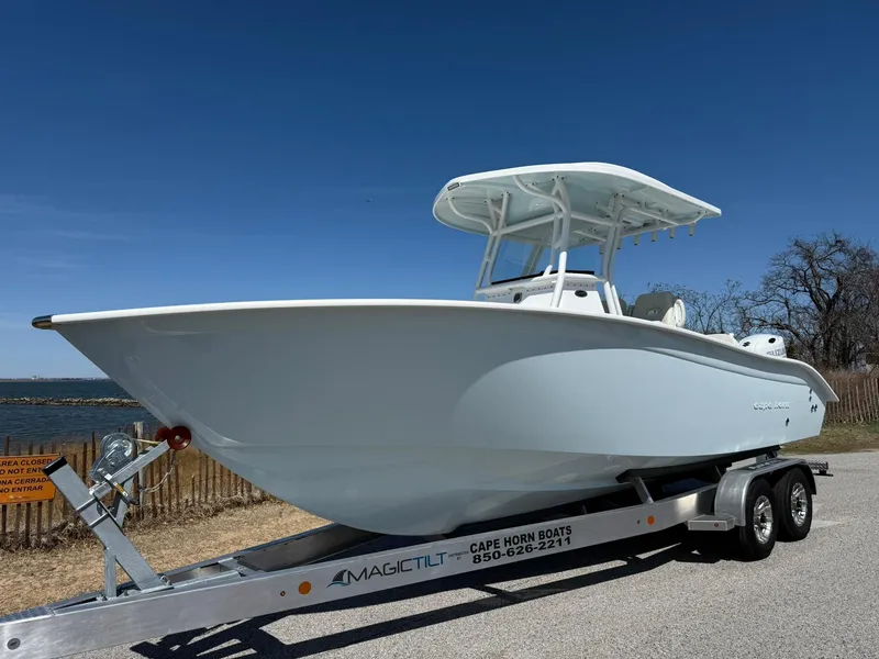 Slide: The Image of 2025 Cape Horn 24 XS boat on trailer, parked outdoors under clear blue sky. - 19