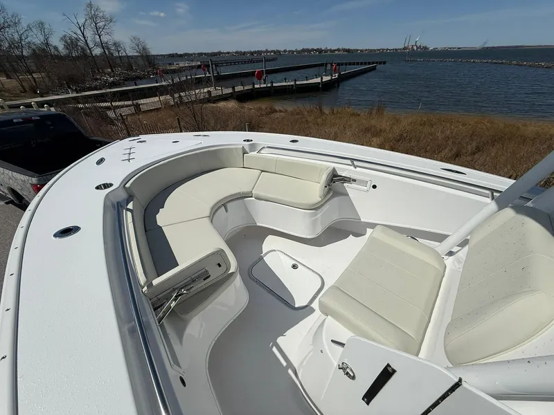 Slide: The Image of 2025 Cape Horn 24 XS boat with spacious seating, docked by a scenic waterfront. - 26