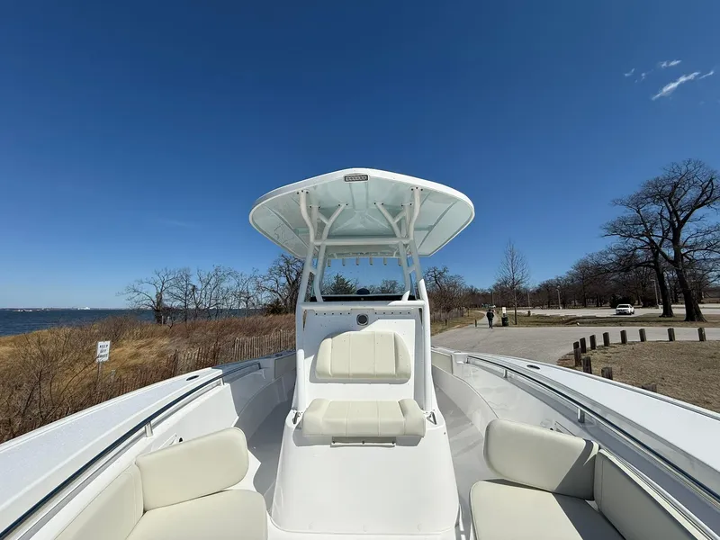 Slide: The Image of 2025 Cape Horn 24 XS boat with seating, clear sky, and coastal background. - 27