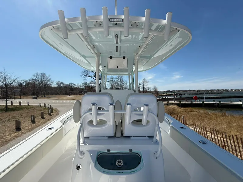 Slide: The Image of 2025 Cape Horn 24 XS boat with dual seats and rod holders, dockside view. - 32