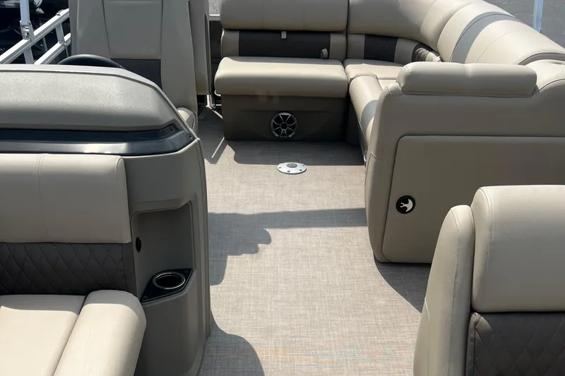 Slide: The Image of 2025 Sun Tracker Party Barge 20 DLX interior with beige seating and spacious layout. - 11