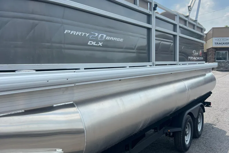Slide: The Image of 2025 Sun Tracker Party Barge 20 DLX pontoon boat on trailer, side view. - 3