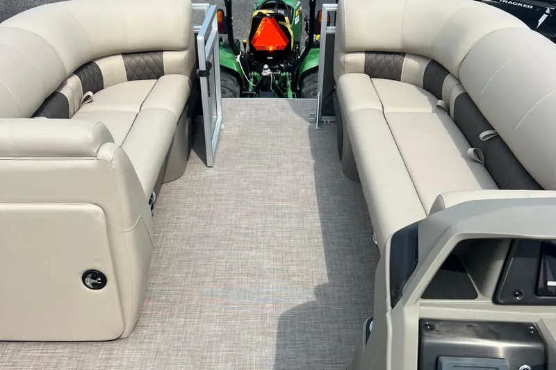 Slide: The Image of 2025 Sun Tracker Party Barge 20 DLX interior with beige seating and open gate. - 6