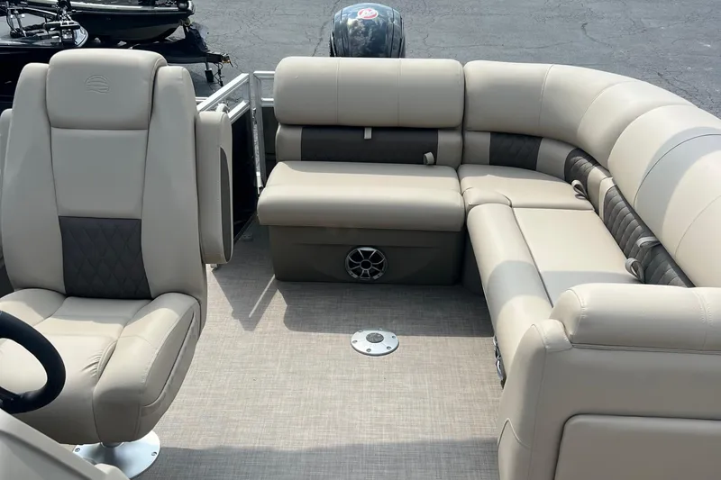 Slide: The Image of 2025 Sun Tracker Party Barge 20 DLX interior with beige seating and spacious layout. - 7