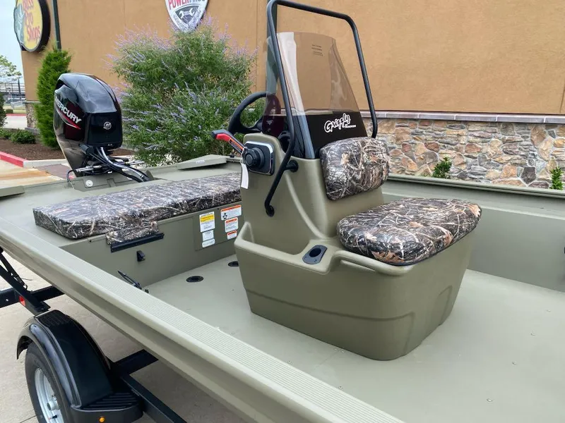 Slide: The Image of 2025 Tracker Grizzly 1860 CC boat with camo seats and Mercury outboard motor. - 2