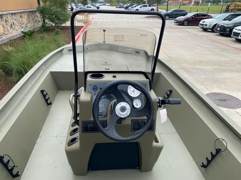 Slide: The Image of 2025 Tracker Grizzly 1860 CC boat interior with steering console and gauges. - 3