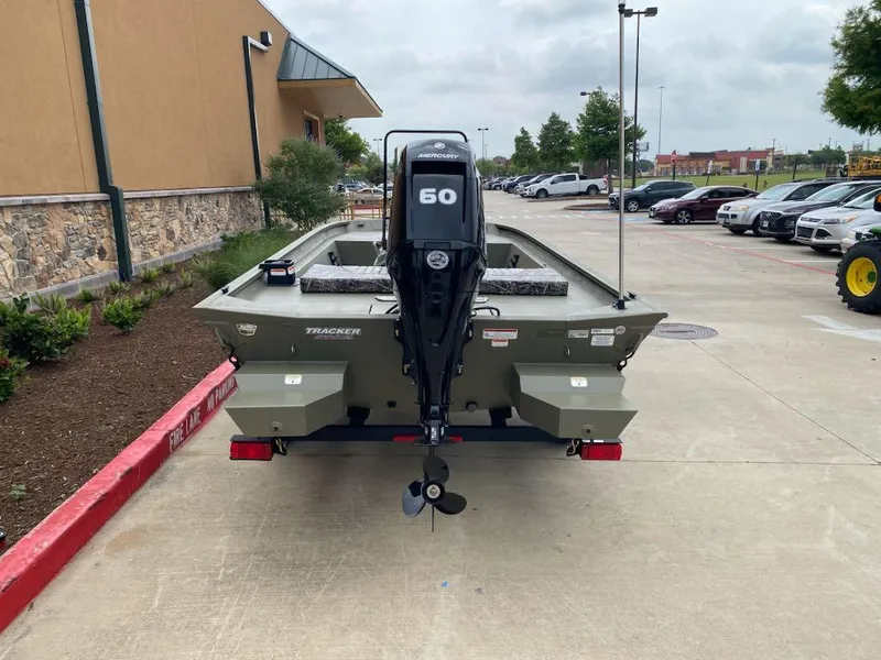 Slide: The Image of 2025 Tracker Grizzly 1860 CC boat with 60 HP motor in parking lot. - 4