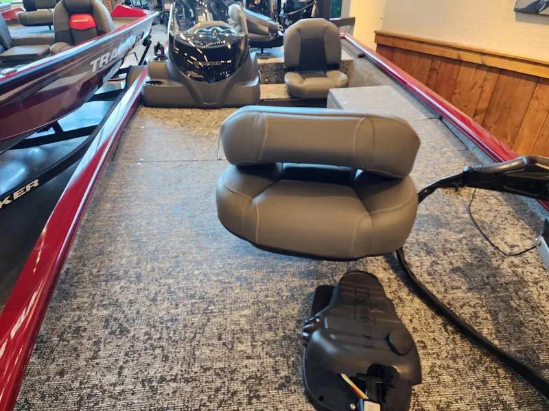 Slide: The Image of 2025 Tracker Pro 170 boat interior with gray seating and carpeted flooring. - 3