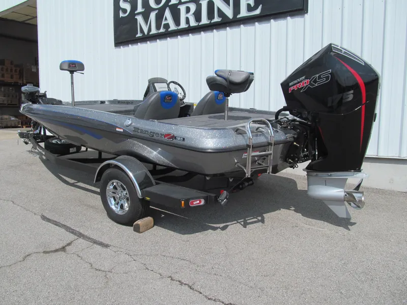 Slide: The Image of 2025 Ranger Z185 boat with powerful outboard motor, parked at a marine store. - 3