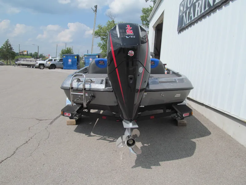 Slide: The Image of 2025 Ranger Z185 boat with powerful outboard motor, parked outside a marina. - 4