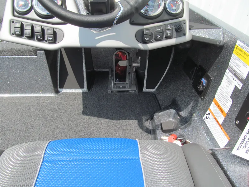 Slide: The Image of 2025 Ranger Z185 boat cockpit with steering wheel, controls, and blue seat. - 7