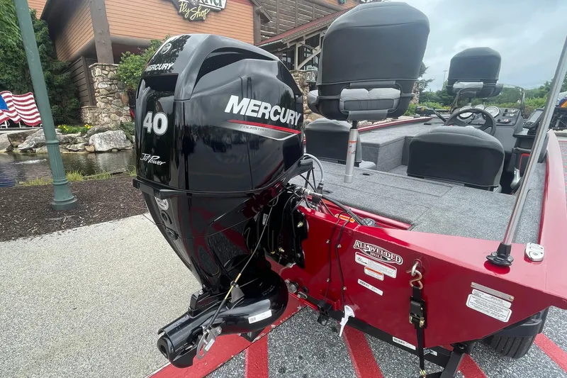 Slide: The Image of 2025 Tracker Pro 170 boat with Mercury 40 HP engine, parked outdoors. - 2