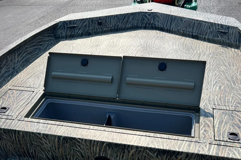 Slide: The Image of 2025 Tracker Grizzly 2072 CC boat with open storage compartments. - 12