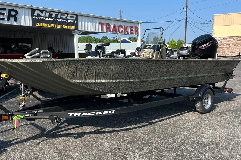 Slide: The Image of 2025 Tracker Grizzly 2072 CC boat on trailer, parked outside dealership. - 2