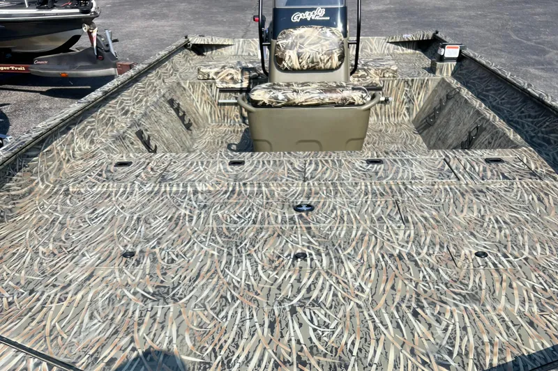 Slide: The Image of 2025 Tracker Grizzly 2072 CC boat with camouflage pattern, ideal for outdoor adventures. - 7