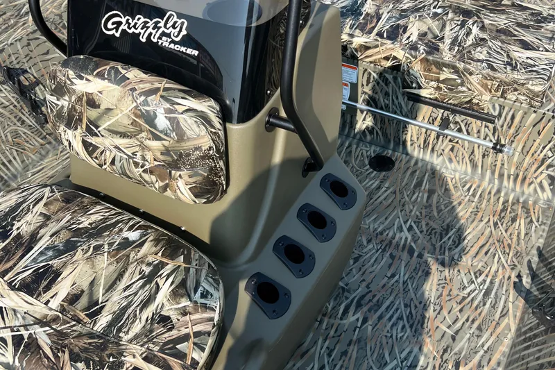 Slide: The Image of 2025 Tracker Grizzly 2072 CC boat with camouflage design and console details. - 8