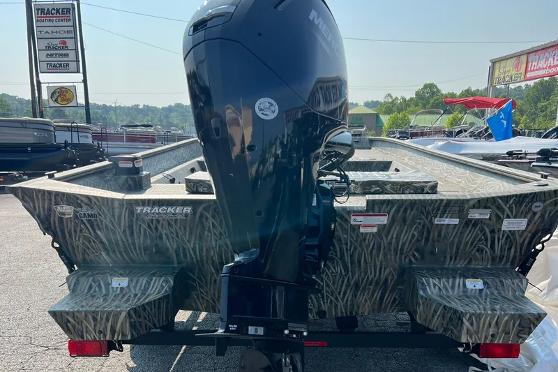 Slide: The Image of 2025 Tracker Grizzly 2072 CC boat with camouflage design and powerful outboard motor. - 9