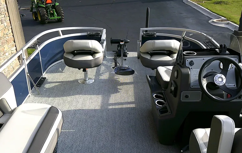 Slide: The Image of 2025 Sun Tracker Bass Buggy 16 XL Select interior with seating and steering console. - 5