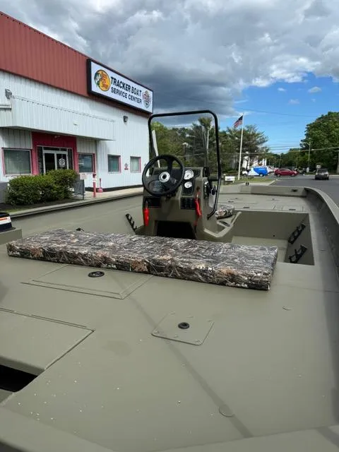 Slide: The Image of 2025 Tracker Grizzly 2072 CC boat at service center, under cloudy sky. - 11
