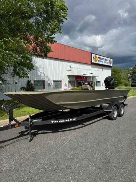 Slide: The Image of 2025 Tracker Grizzly 2072 CC boat on trailer outside service center. - 4