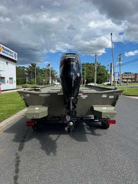 Slide: The Image of 2025 Tracker Grizzly 2072 CC boat on trailer, parked outdoors near service center. - 5
