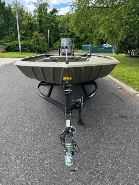 Slide: The Image of 2025 Tracker Grizzly 2072 CC boat on trailer, parked on a road with greenery. - 6
