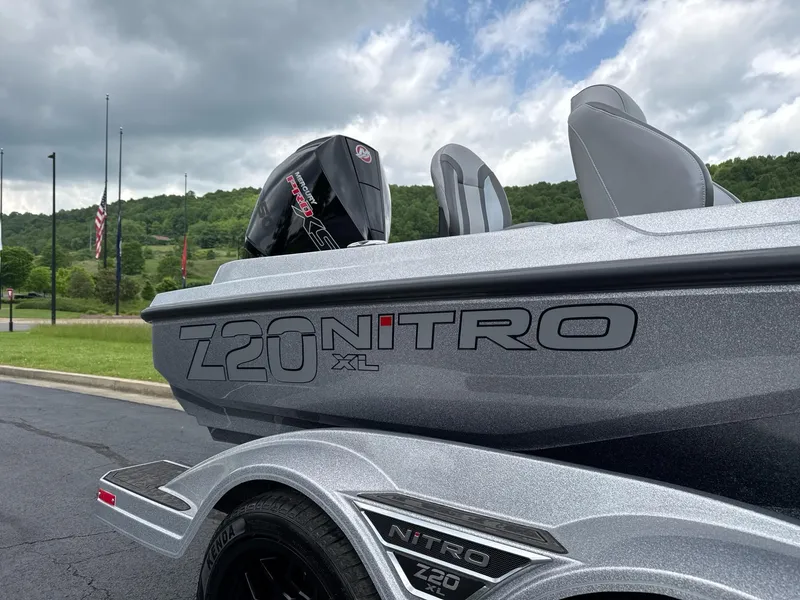 Slide: The Image of 2025 Nitro Z20 XL boat with sleek design, parked outdoors under cloudy sky. - 2