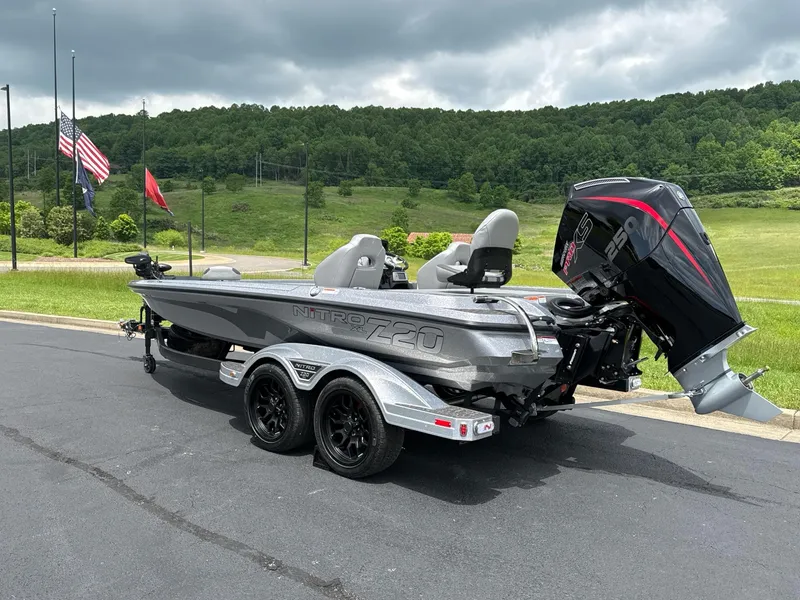 Slide: The Image of 2025 Nitro Z20 XL boat with powerful outboard motor, parked on a scenic road. - 3