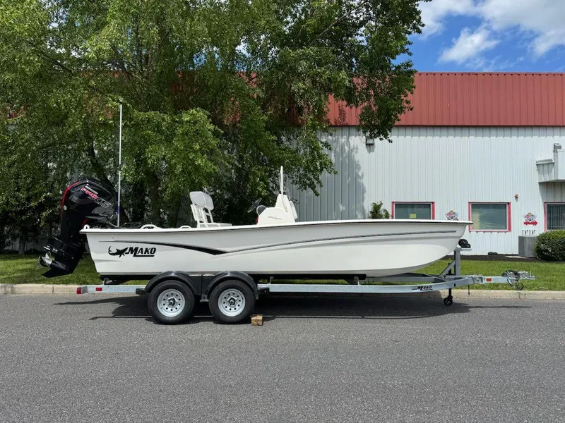The Image of 2025 Mako Pro Skiff 19 CC boat on trailer, parked outdoors. - 0
