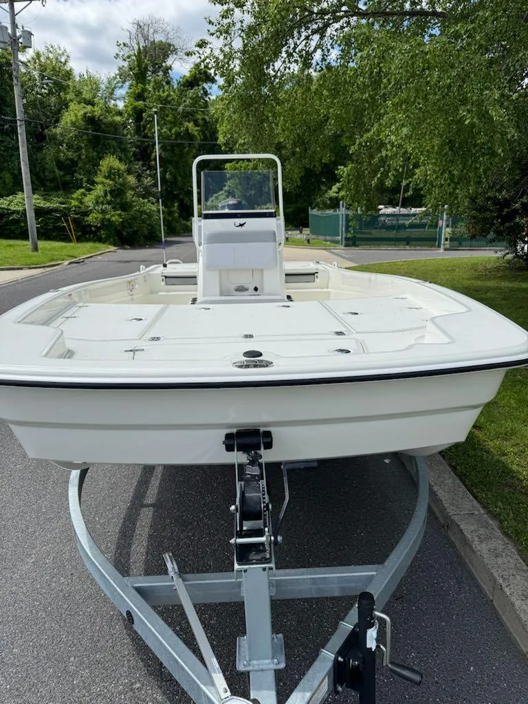 Slide: The Image of 2025 Mako Pro Skiff 19 CC boat on trailer, parked outdoors. - 3