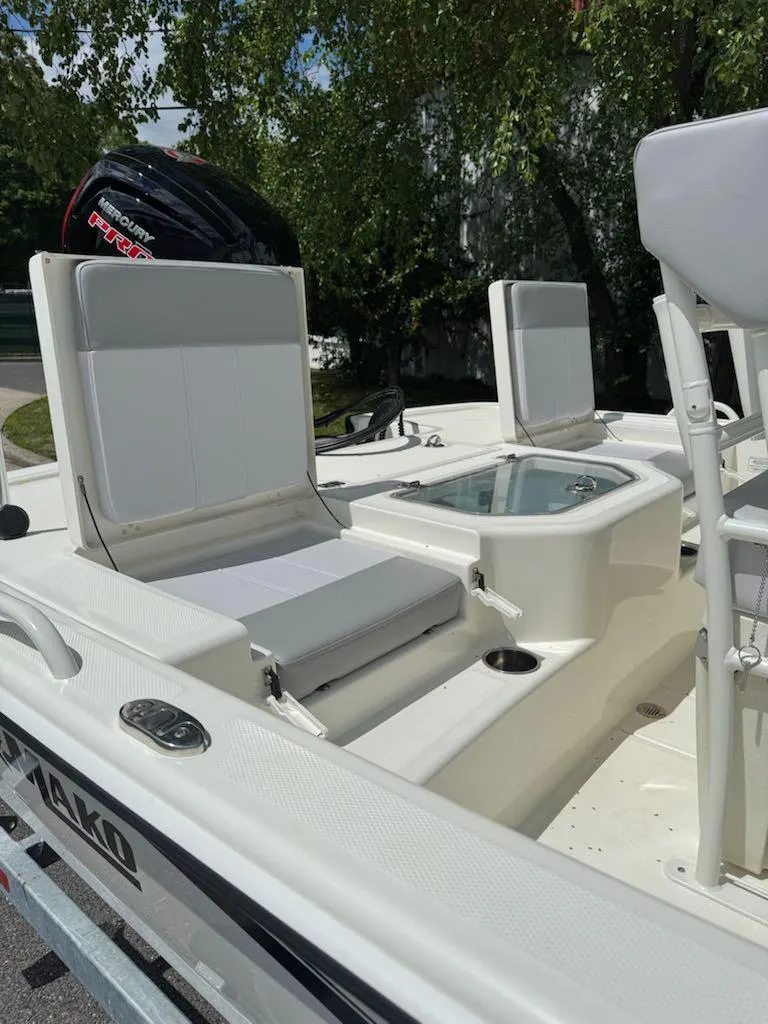 Slide: The Image of 2025 Mako Pro Skiff 19 CC boat interior with seating and storage. - 8