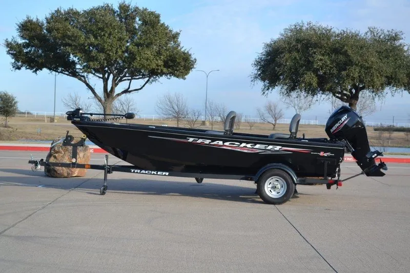 The Image of 2025 Tracker Super Guide V-16 T boat on trailer, parked outdoors. - 0