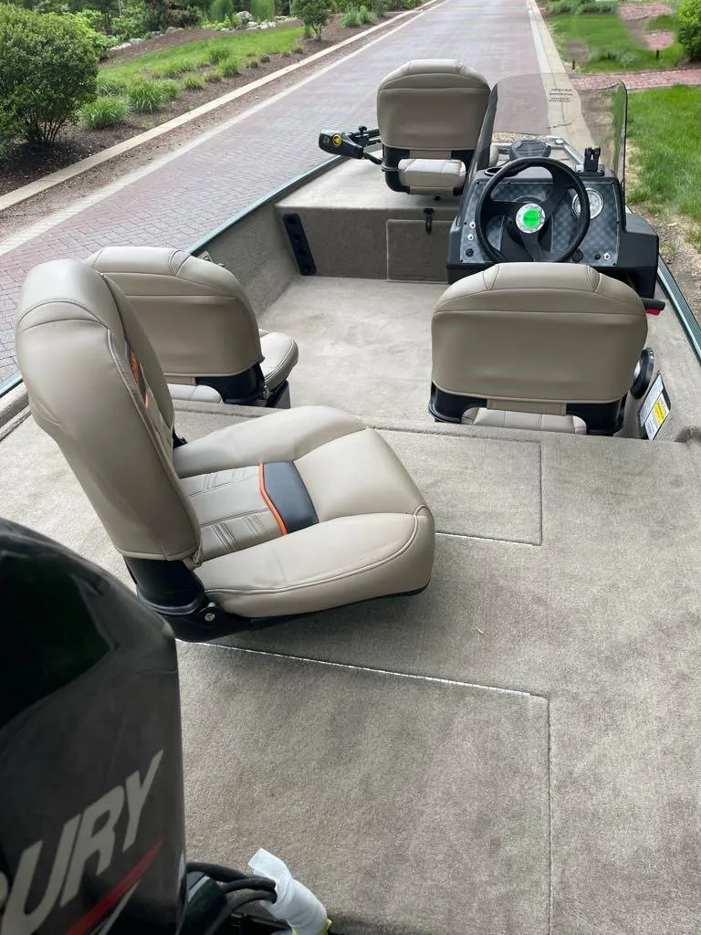 Slide: The Image of 2025 Tracker Bass Tracker Classic Limited boat interior with beige seats and steering console. - 4