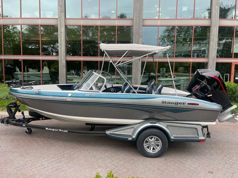 The Image of 2025 Ranger 1850MS boat with canopy on trailer, parked outdoors. - 0